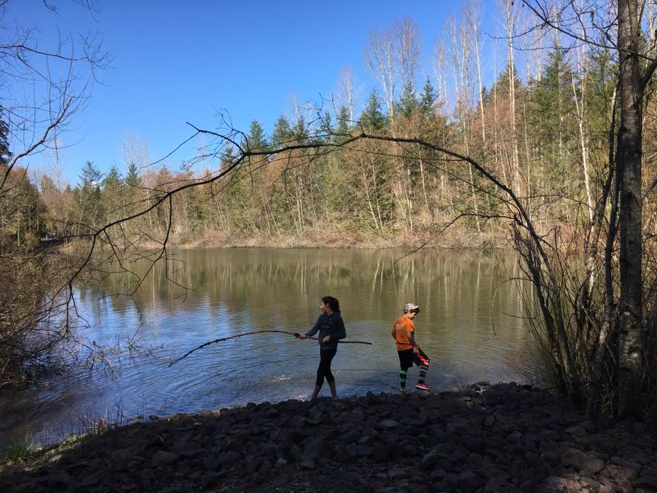 Two children alongside a lake