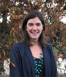 Photograph of Kate Bedient smiling in front of a tree